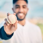 Baseball field, portrait and pitcher holding ball on match or game day on a sports ground or pitch .
